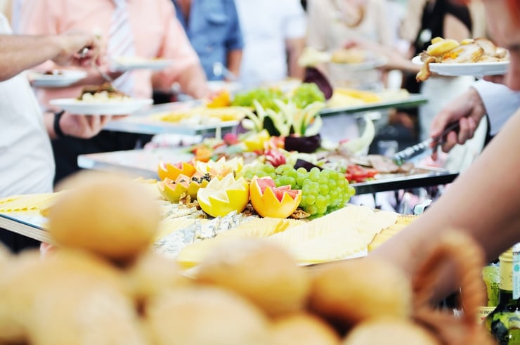 people choosing food from table on catering and buffet party on business seminar conference or wedding